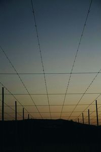 Low angle view of electricity pylon against sky