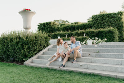 Rear view of woman sitting on steps