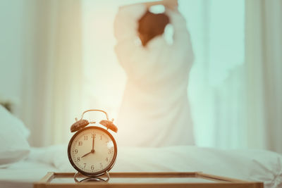 Close-up of woman hand on bed at home