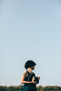 Woman standing against clear sky