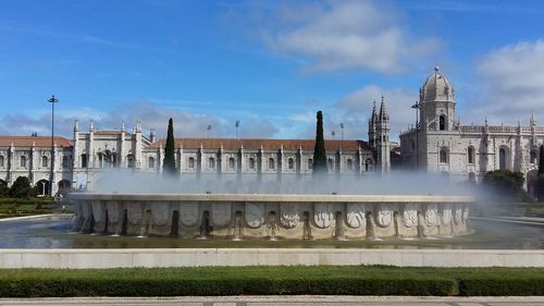 View of fountain in city against sky