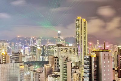 Illuminated cityscape against sky at night