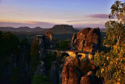 Panoramic view of rock formations against morning sky