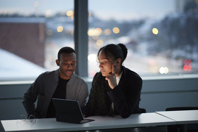 Colleagues working late in office