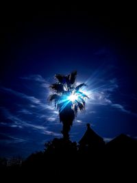 Low angle view of silhouette light against sky at night