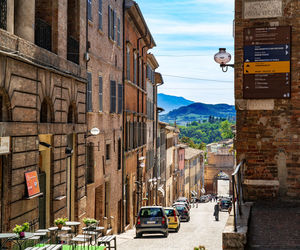 Cars on street amidst buildings in city