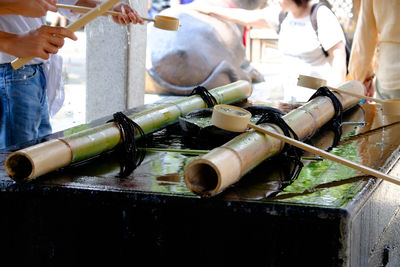 Cropped image of people by equipment on table