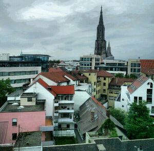 Residential buildings against cloudy sky