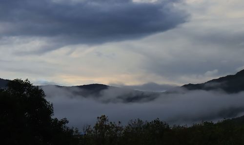 Scenic view of silhouette mountains against sky