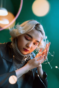 Close-up of woman holding illuminated lights