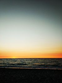 Scenic view of sea against clear sky during sunset