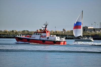 Ship sailing on sea against clear sky