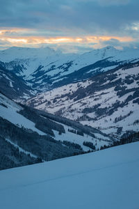 Scenic view of snowcapped mountains against sky during sunset