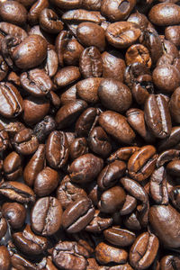 Full frame shot of roasted coffee beans against white background