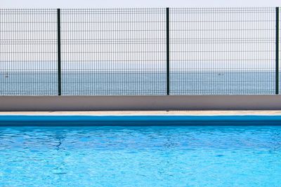 Swimming pool against blue sea