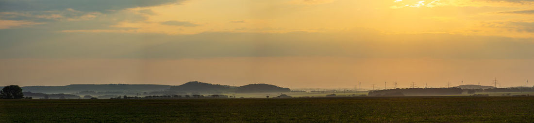 Scenic view of field against sky during sunset