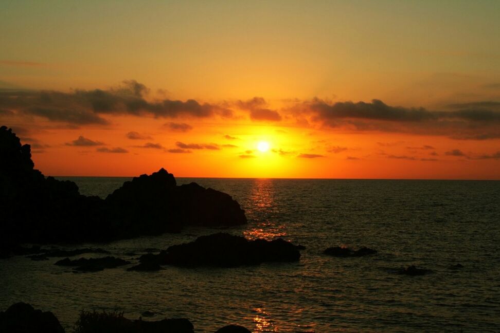 sea, sunset, horizon over water, water, scenics, tranquil scene, beauty in nature, tranquility, rock - object, rock formation, sky, orange color, idyllic, nature, sun, rock, cliff, beach, silhouette, remote