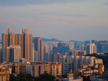 View of skyscrapers against cloudy sky