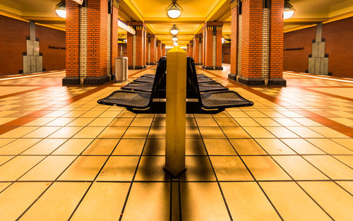 Empty seats at illuminated subway station