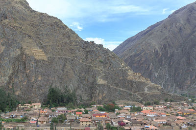 Town by mountains against sky