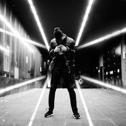 Full length of man standing in illuminated city