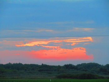 Scenic view of field against sky during sunset