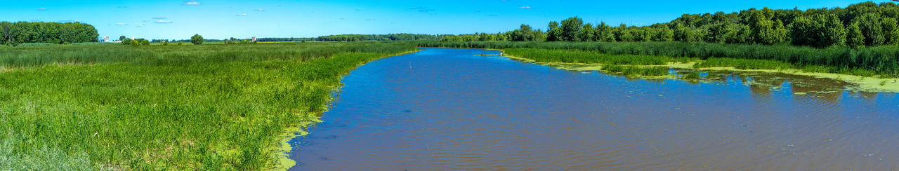 Scenic view of land against blue sky