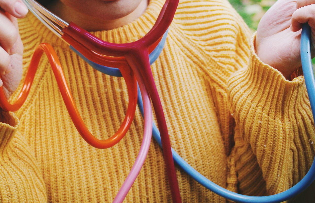 Midsection of woman with stethoscope