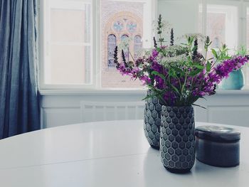 Flower vases on dining table at home