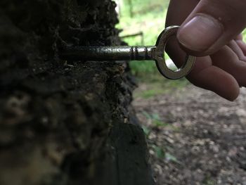 Close-up of man working on chain