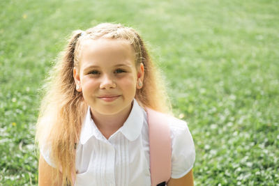 Portrait of smiling young woman standing against plants