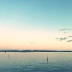 Scenic view of sea against clear sky during sunset