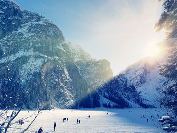 Scenic view of snowcapped mountains against sky during sunny day