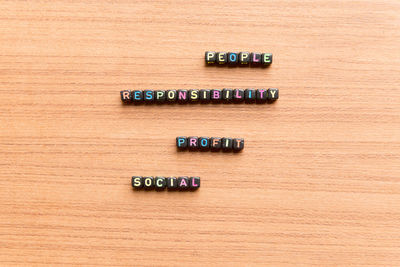 High angle view of colorful text on wooden table