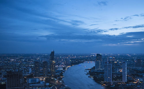 Aerial view of city against blue sky