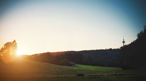 Scenic view of landscape against clear sky during sunset