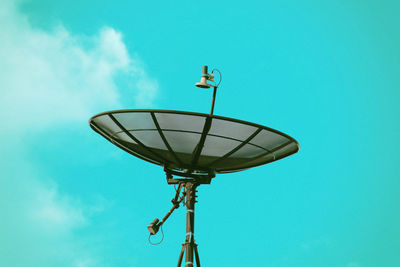 Low angle view of street light against blue sky