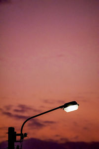 Low angle view of street light against sky during sunset