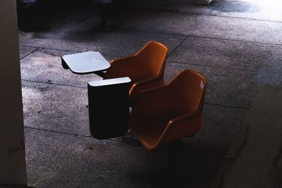 High angle view of chair on sidewalk