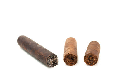 Close-up of cigarette over white background