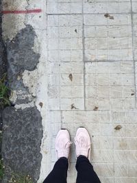 Low section of woman standing on tiled floor