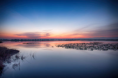 Scenic view of beach against sky during sunset