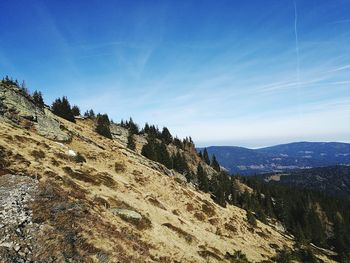 Scenic view of mountains against blue sky