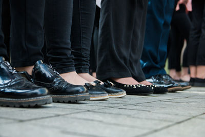 Low section of people standing on footpath