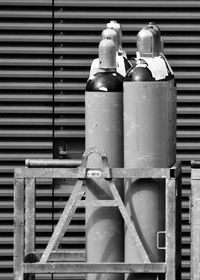 Close-up of oxygen tanks by door