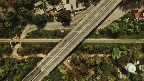 High angle view of highway amidst trees in city