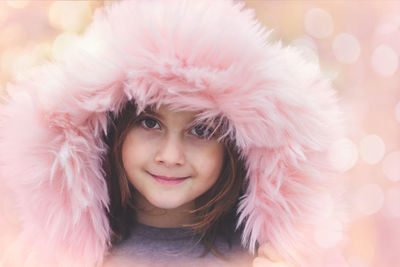 Close-up portrait of smiling woman in pink hat