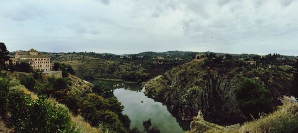 Panoramic shot of trees on landscape against sky