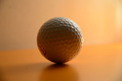 Close-up of golf ball on table