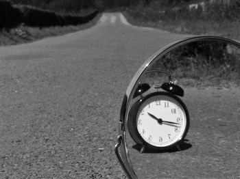 Close-up of clock on road